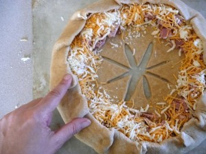 Ham and Cheese Stuffed Bread Wreath: fold over the edges of the dough over the filling